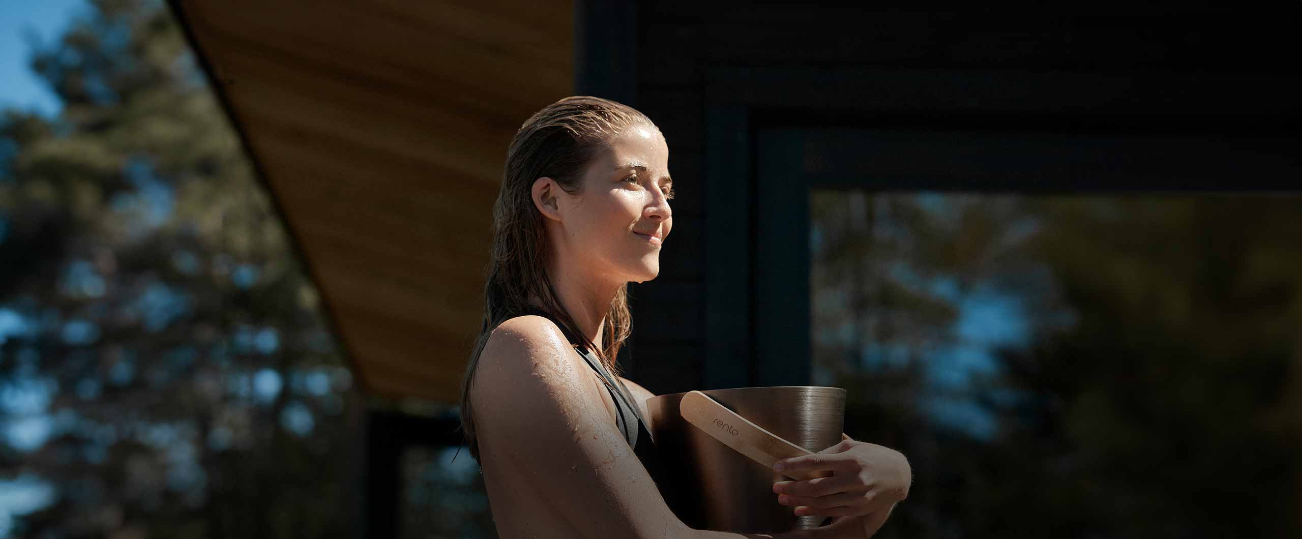 woman holding a sauna bucket